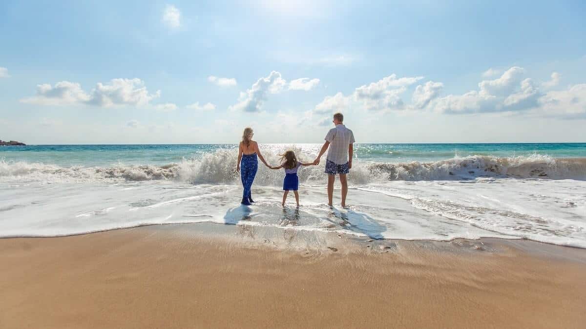 a family who took out a vacation loan spends time on a beach