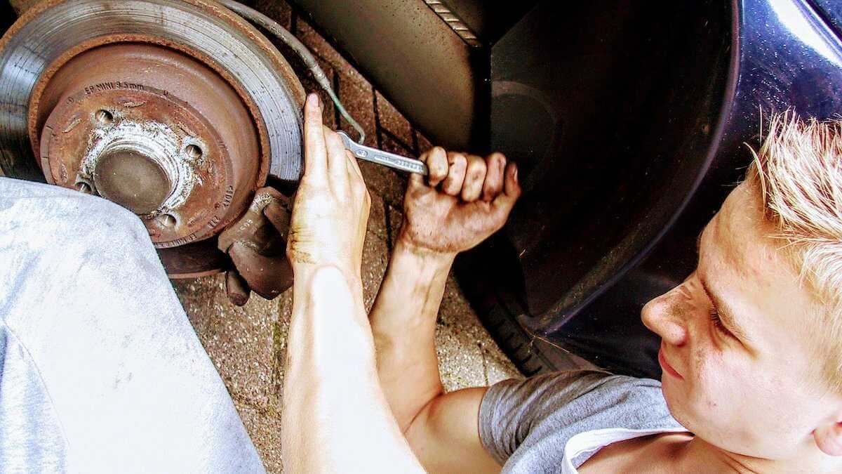 a mechanic fixing the brakes of a car