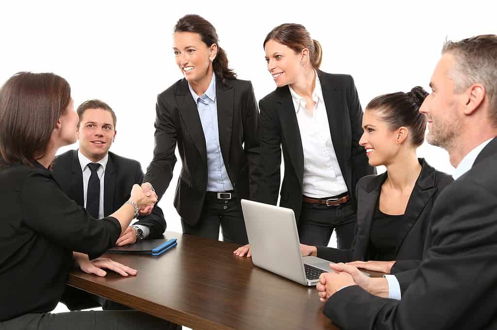 group of people shaking hands in a meeting