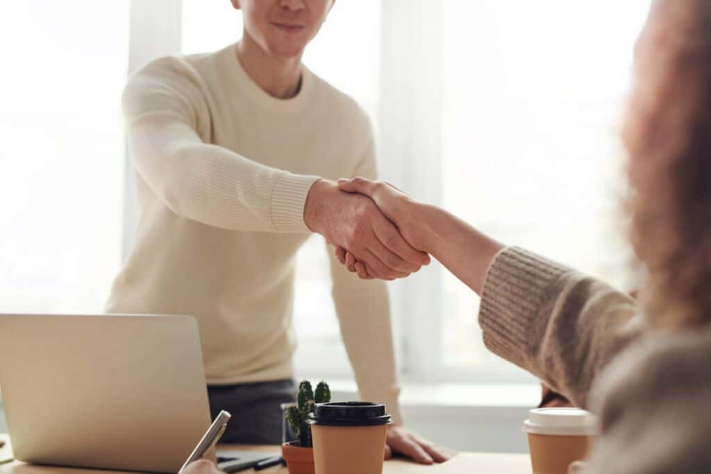 Man and Woman shaking hands Near Table